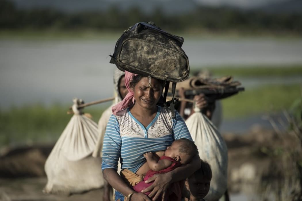 A Rohingya refugee walks after crossing the Naf river from Myanmar into Bangladesh.