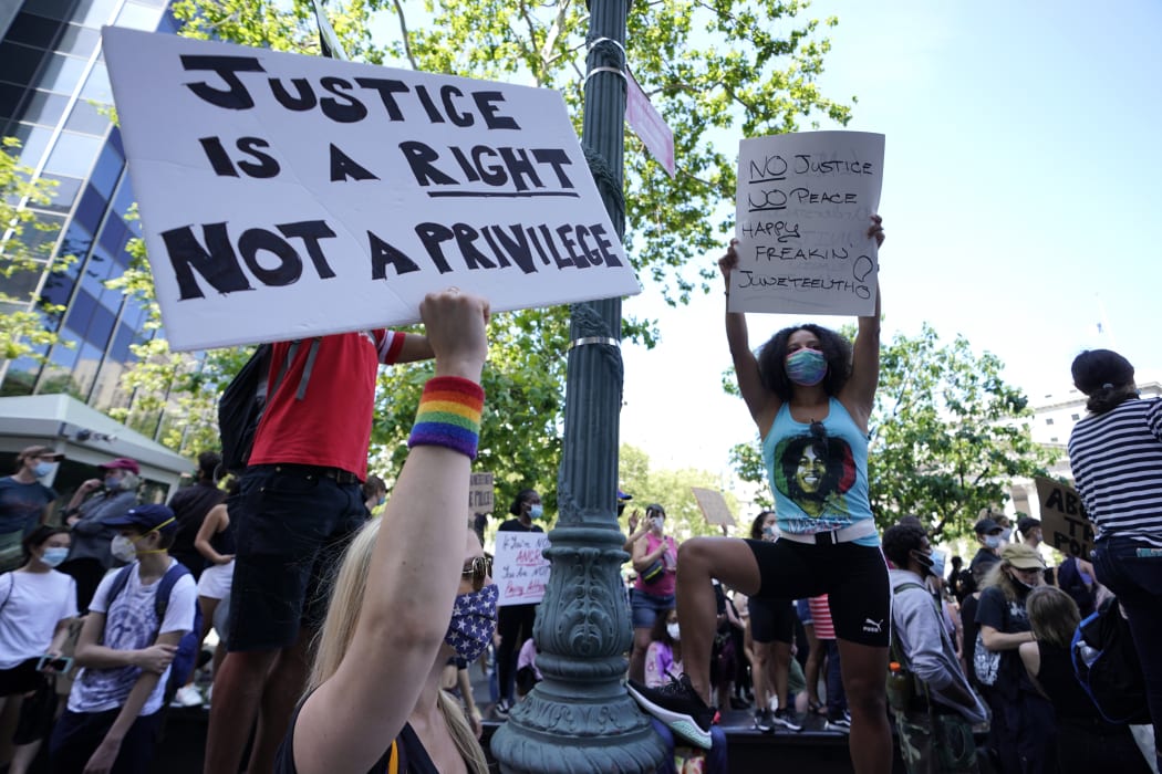 Protestors hold signs in New York City's Foley Square during a Juneteenth rally on 19 June.