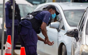 Security officers man a checkpoint at a junction in the Fijian capital Suva.