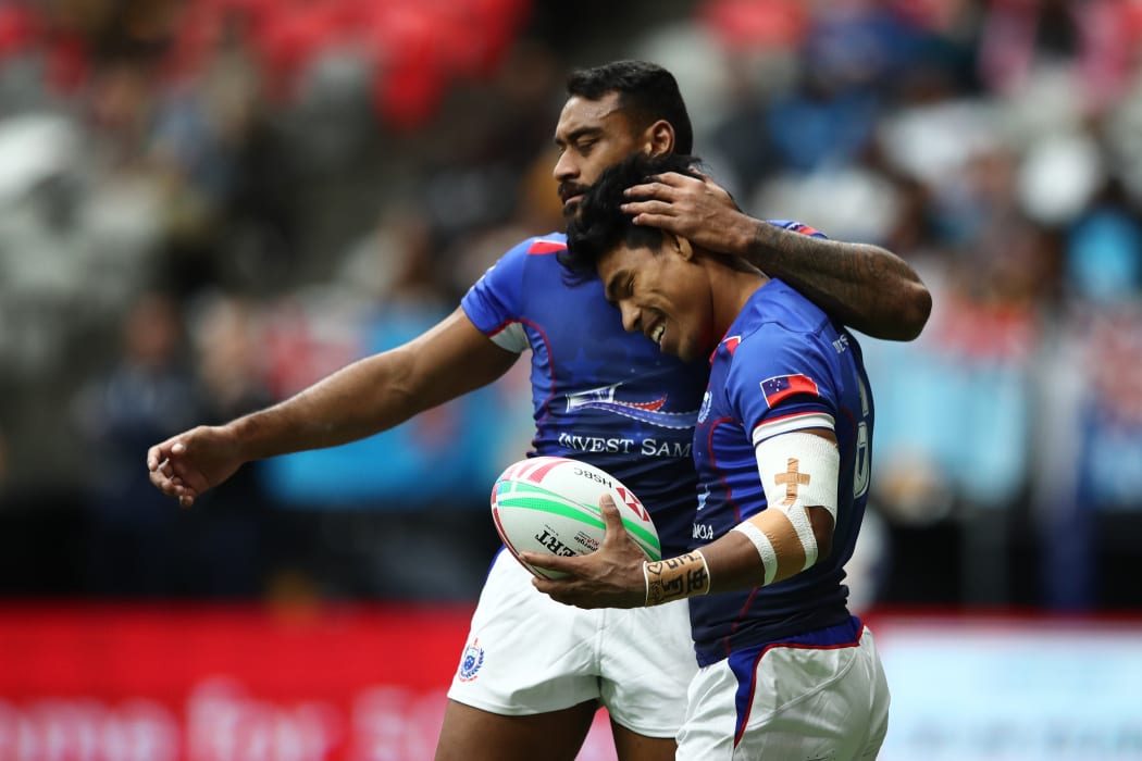 Samoa captain David Afamasaga and Murphy Paulo celebrate a try.