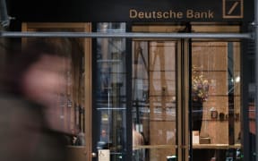 People walk by the New York headquarters of Deutsche Bank, April 2019.