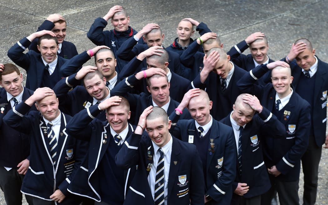 Otago Boys' High School students hold their freshly shaved lids in their hands.