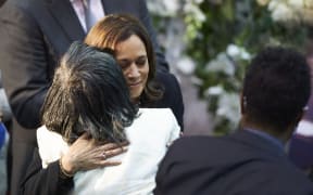 US Vice President Kamala Harris hugs Robin Harris, daughter of shooting victim Ruth Whitfield during her funeral service at Mount Olive Baptist Church in Buffalo, New York, on May 28, 2022. - Whitfield, 86, was killed in the racially motivated May 14 Buffalo mass shooting at Tops Friendly Market. She was the oldest of 10 people killed. (Photo by Geoff Robins / AFP)
