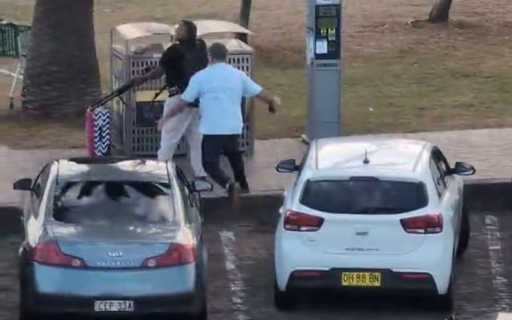 A man in civilian clothing pounces on the shooter.