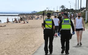 Police enforcing Covid-19 restrictions patrol Elwood Beach in Melbourne in the weekend.
