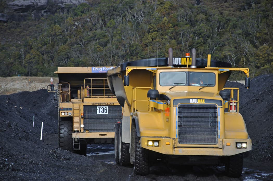 Huge trucks move high-grade coal from a stockpile at the Stockton Mine near Westport.