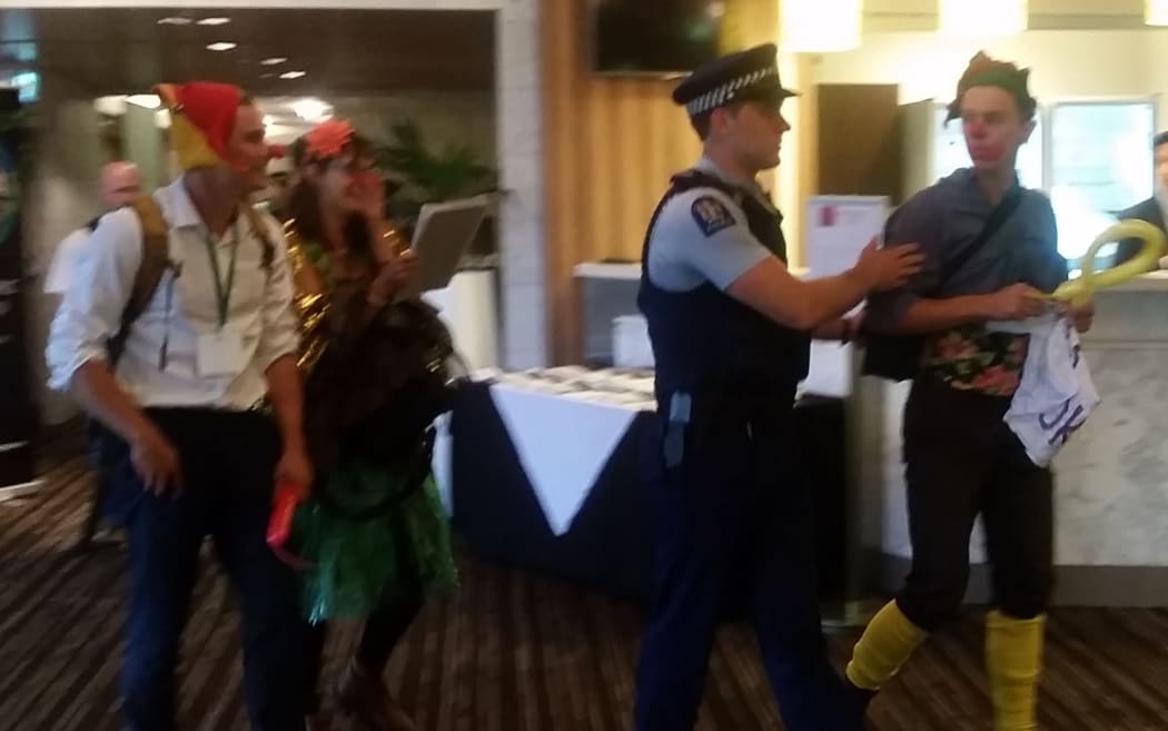 Police remove protestors from TPP roadshow.