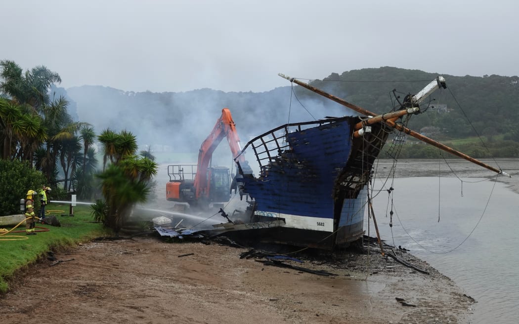 A digger demolishes what's left of the Tui before high tide can sweep the debris into the Bay of Islands.