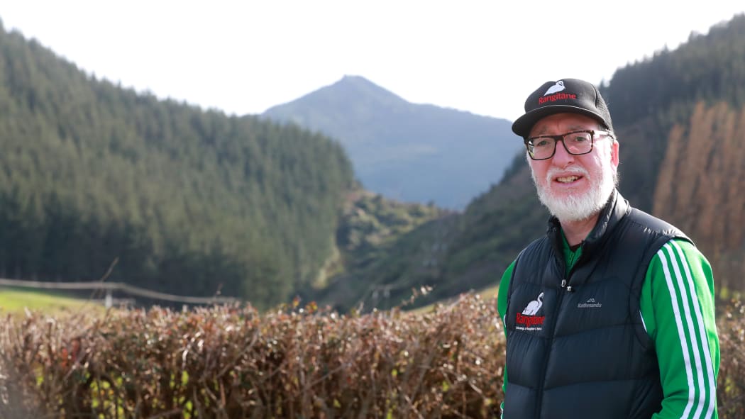 Massey University Māori historian and senior lecturer Dr Peter Meihana. The ancestress Hinekoareare was interred on the peak behind him. When the peak is called Mt Strachan that important story and its relation to other landmarks is lost.