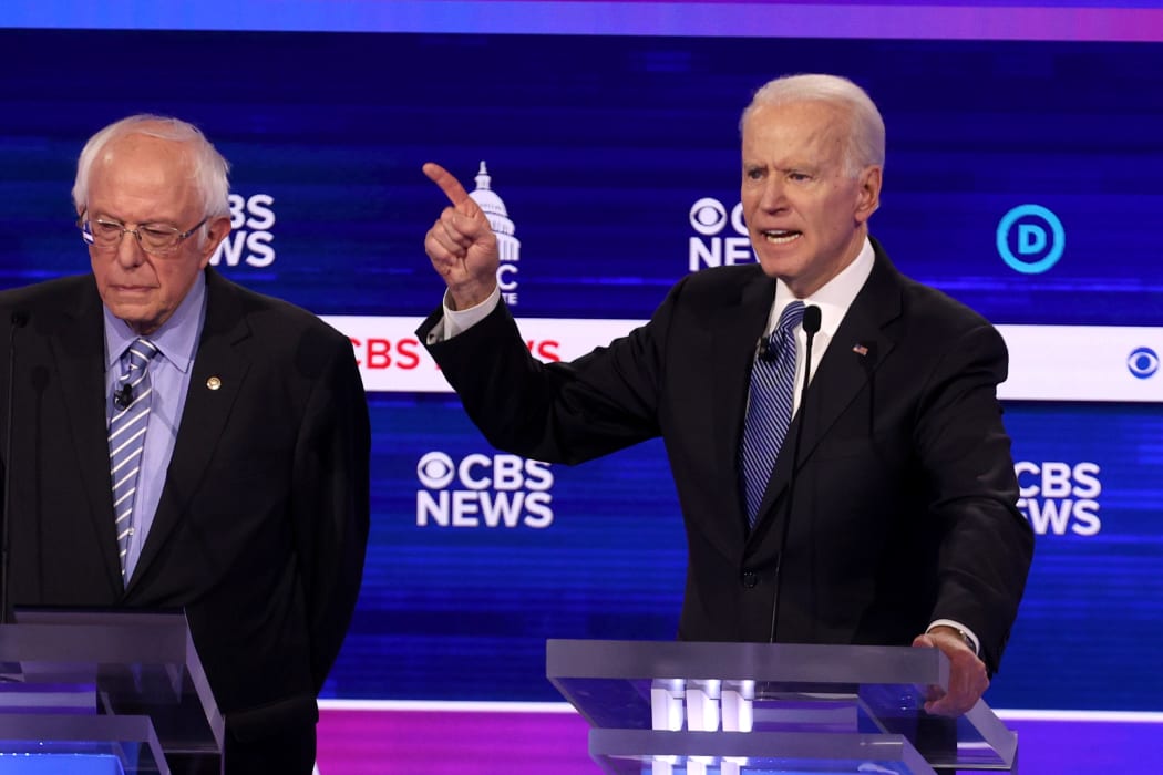 Democratic presidential candidate former Vice President Joe Biden speaks as Bernie Sanders looks on during the debate at the Charleston Gaillard Center on February 25, 2020.