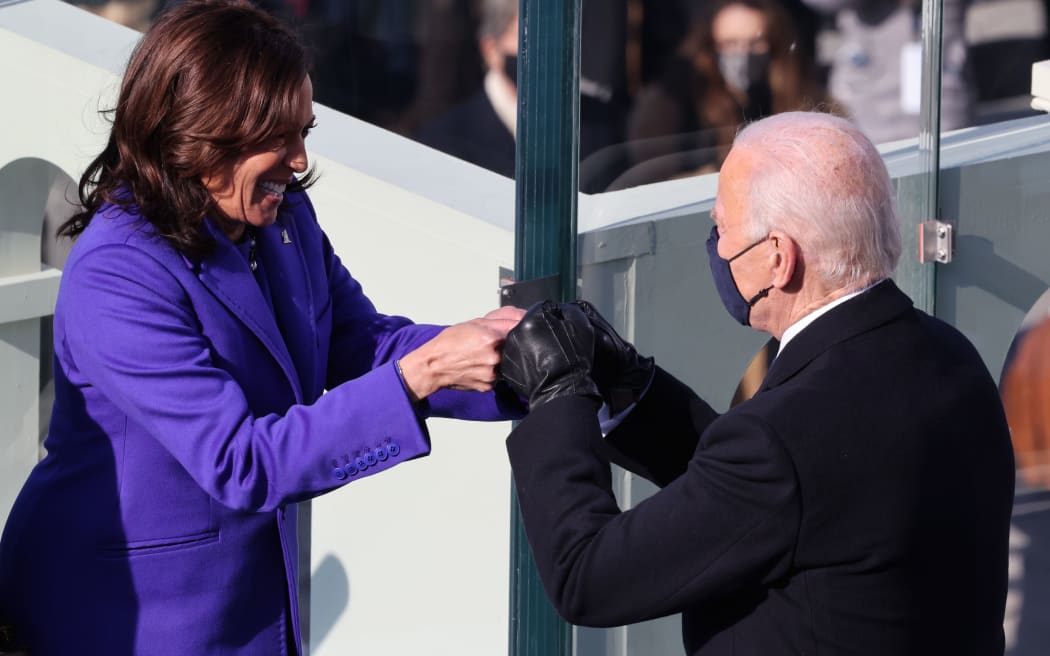 WASHINGTON, DC - JANUARY 20: Vice President Kamala Harris celebrates with President-elect Joe Biden after being sworn in during the inauguration on the West Front of the U.S. Capitol on January 20, 2021 in Washington, DC.