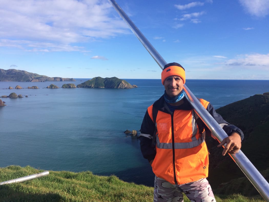 Dr Dan Hikuroa at Rangitoto ki te Tonga holds an aluminum core tube as part of fieldwork research.