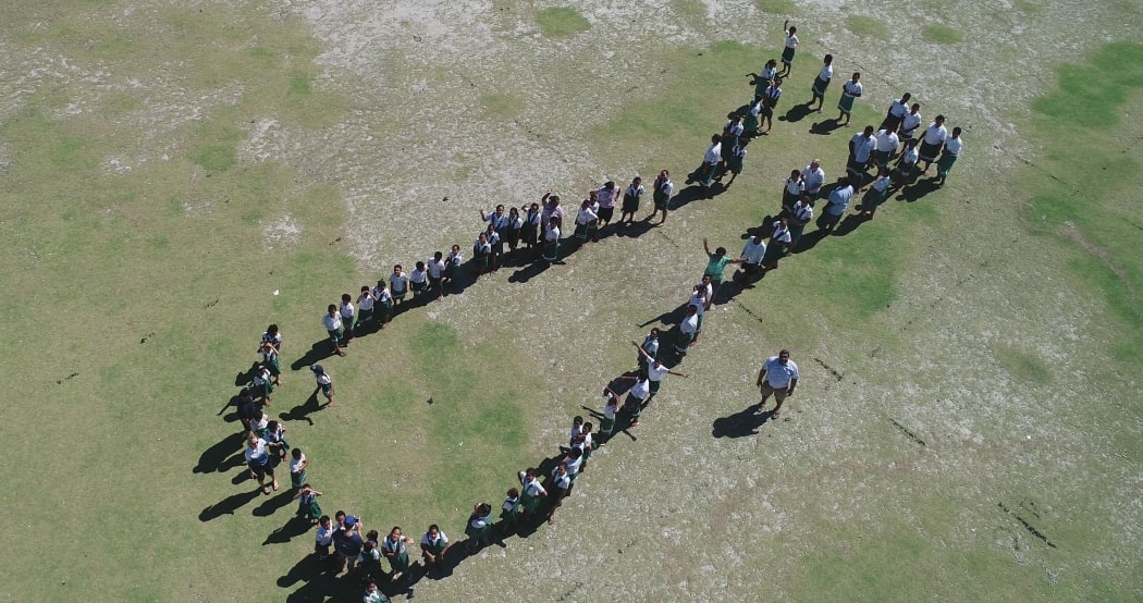 School children at Nukunonu school form whale shark shape