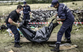 Ukrainian State Emergency Service employees collect a victim's body.