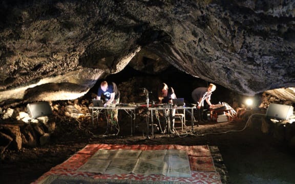 Musicians and sound artists performing Speleo Sonics concert in a cave