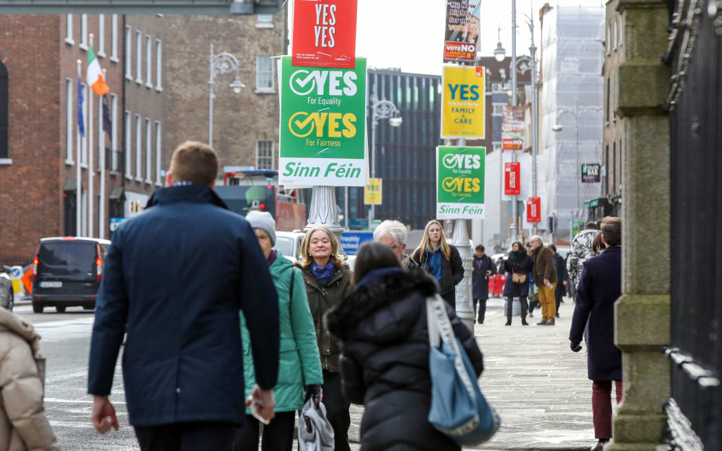 "Yes" and "No" posters are seen in the street outside Goverment buildings in Dublin, Ireland on March 5, 2024, ahead of the Irish Referendum on Friday. Ireland prepares to vote Friday on constitutional references to the family and women's role in the home after campaigns that have honed in on vague wording, 'mansplaining' and panic over polygamy. (Photo by PAUL FAITH / AFP)