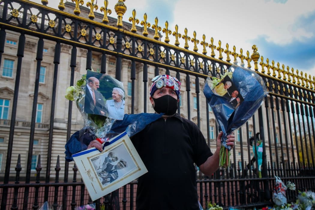 Mourners gather outside Buckingham Palace following the announcement of the death of The Prince Phillip, Duke of Edinburgh at the age of 99 on Friday 9th April 2021.