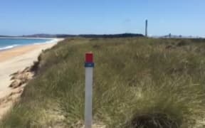 The beach east of Tiwai Point smelter where spent cell liner waste is kept under an impermeable cover.