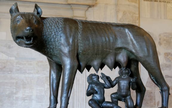 A bronze statue of a she-wolf depicts with twins Romulus and Remus suckling.