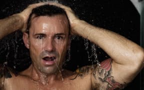 Man washing his hair in shower (Photo by Robin Skjoldborg / Cultura Creative / Cultura Creative via AFP)
