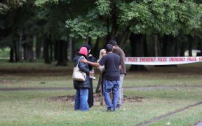 Police taping off the street out Christchurch mosque, people reunite