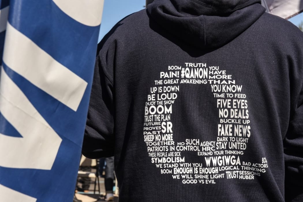 A person wearing a QAnon sweatshirt during a pro-Trump rally in New York City. The event, which was organized weeks ago, encouraged people to vote Republican and to pray for the health of President Trump who fell ill with Covid-19.