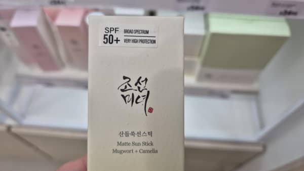 Beauty of Joseon sunscreen's sun stick package in Farmers shows an additional sticker applied that says "broad spectrum, very high protection".