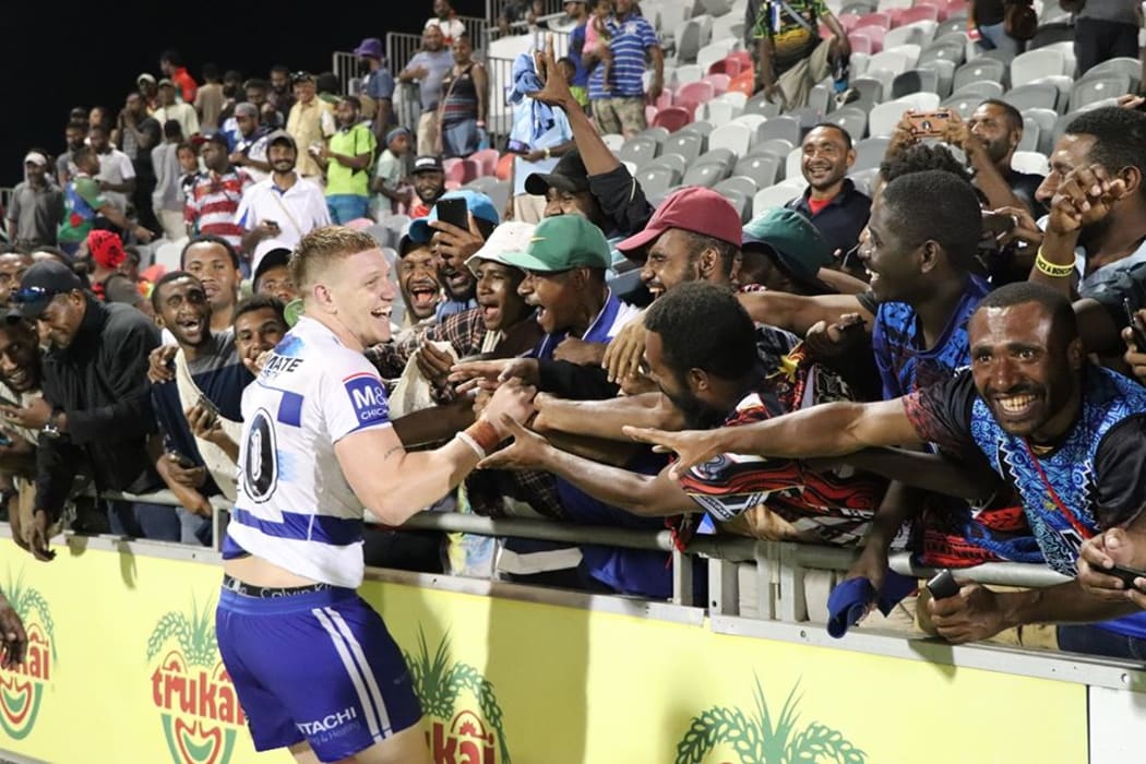 PNG crowd embrace Bulldogs prop Dylan Napa at the historical trial match held in Port Moresby.