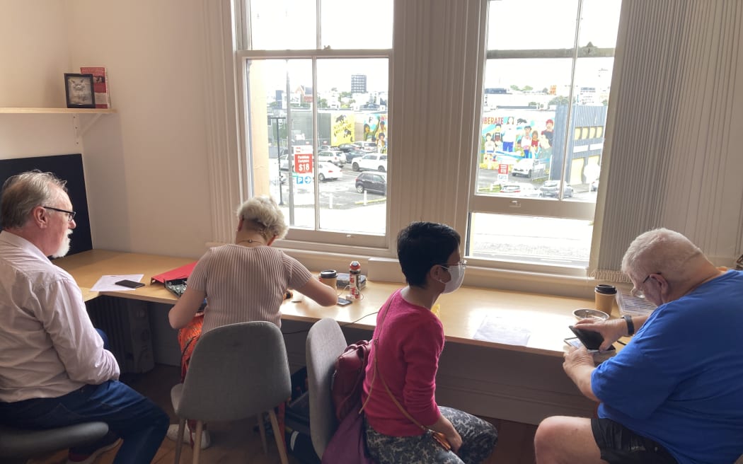 People getting their items looked at at a Repair Cafe on Karangahape Road in Auckland.