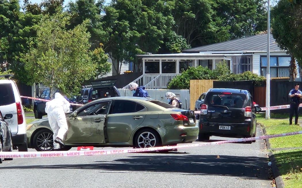 The scene on Addington Ave in Manurewa, Auckland after two men were found with serious injuries in a car.