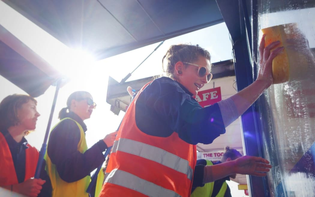 TPP protest group "Show Us Ya Text" at Trade Minister Tim Groser's office in Auckland, washing his windows in a symbolic push for more transparency.