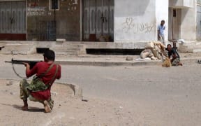 Yemeni supporters of the southern seperatist movement fire towards Houthi rebels.