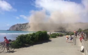 A huge dust cloud follows the collapse of a cliff near Sumner.