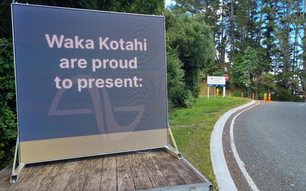 Mystery surrounds tongue in cheek digital billboard placed by an intersection where Waka Kotahi has recently finished work. Junction Road and State Highway 3.