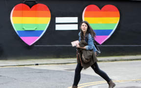 A woman walks past a mural backing same-sex marriage in Ireland on 21 May.
