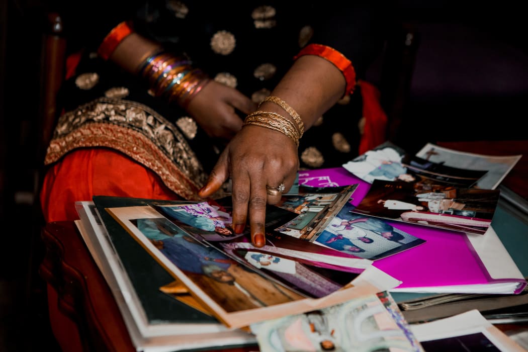 Halima points to a family photo
