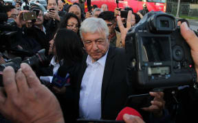 01 July 2018, Mexico, Mexiko City: Politician Andres Manuel Lopez Obrador (C), presidential candidate for the party Morena, speaking to journalists after casting his vote in the election.