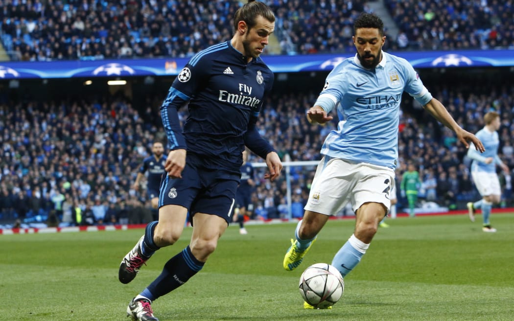 Real Madrid's Gareth Bale takes on a Manchester City defender.