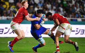 Italy's flanker Sebastian Negri (C) is tackled by Canada's fly-half Peter Nelson (L) and Canada's centre Ciaran Hearn (R)  during the Japan 2019 Rugby World Cup Pool B match between Italy and Canada at the Fukuoka Hakatanomori Stadium