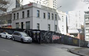 The former Fitzroy Hotel on the corner of Wakefield and Lyndock streets in Auckland CBD in July 2024. Half of Lyndock Street was boarded up but recently workers came back and totally blocked off Lyndock Street with hoardings.