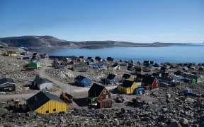 This photograph taken on August 17, 2023, shows the remote Eastern Greenland village of Ittoqqortoormiit, that has a population of approximately 300 inhabitants, in Scoresby Sound Fjord, Eastern Greenland.