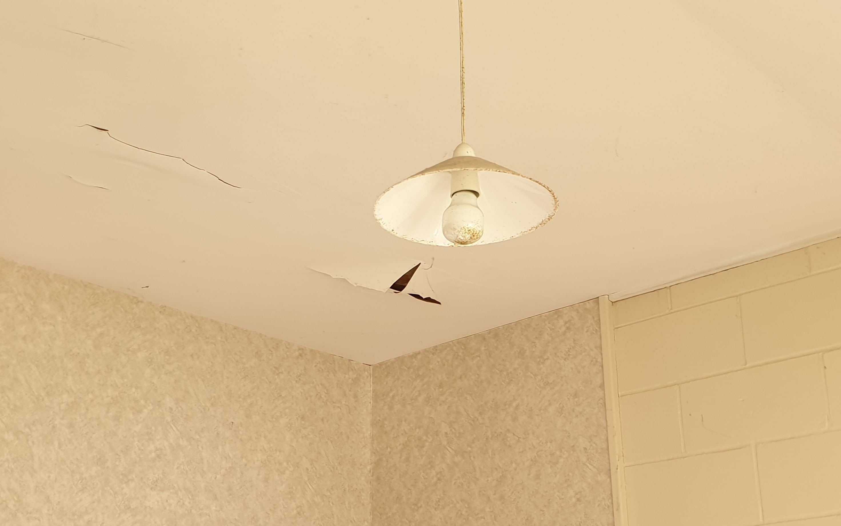 Frank Poissonnier shows the conditions of his cold social housing home, where a layer of the ceiling appears to be coming off.