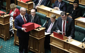 Associate Finance Minister David Clark holds the box of printed budget speeches for the Finance Minister Grant Robertson to hand out.