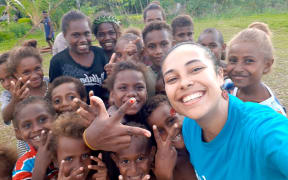 Gladys Habu shares a moment with children in Malaita during her outreach work with UNICEF on maternal and child health.