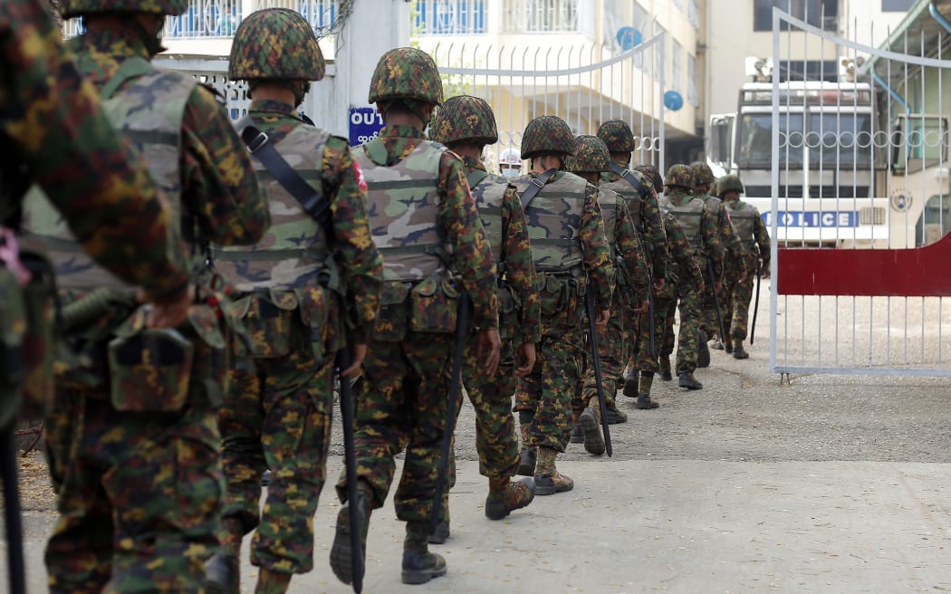 Myanmar soldiers patrol during a demonstration against the military coup outside the Central Bank in Yangon.