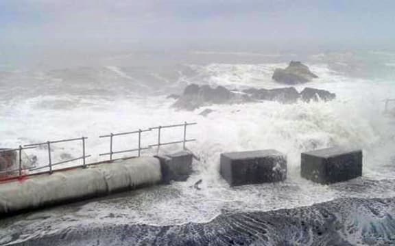 Last night's storm pushed the temporary sea wall blocks onto the road