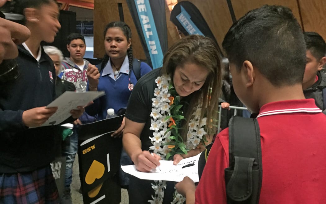Black Ferns captain Fiao'o Fa'amausili signs autographs for fans at the celebrations