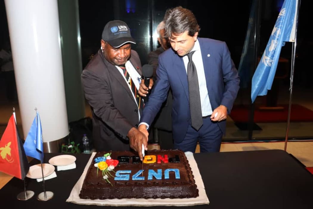 Papua New Guinea Prime Minister James Marape and the United Nations' Resident Co-ordinator Gianluca Rampolla cut cake at a Partnership Dialogue in Port Moresby to mark 75 years of existence of the UN, 3 November 2020.