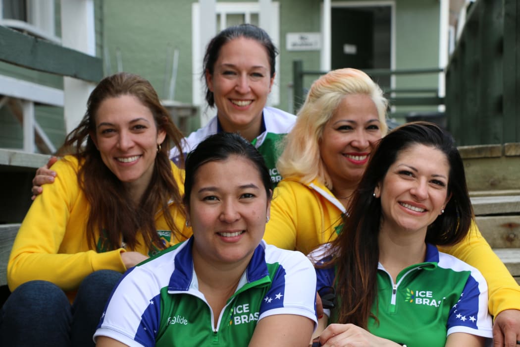 Brazil’s women’s team (L-R: Luciana Barrella, Anne Shibuya, coach Barbara Zbeetnoff, Alessandra Barros and Debora Monteiro) became interested in curling after seeing it during the 2010 Winter Olympics