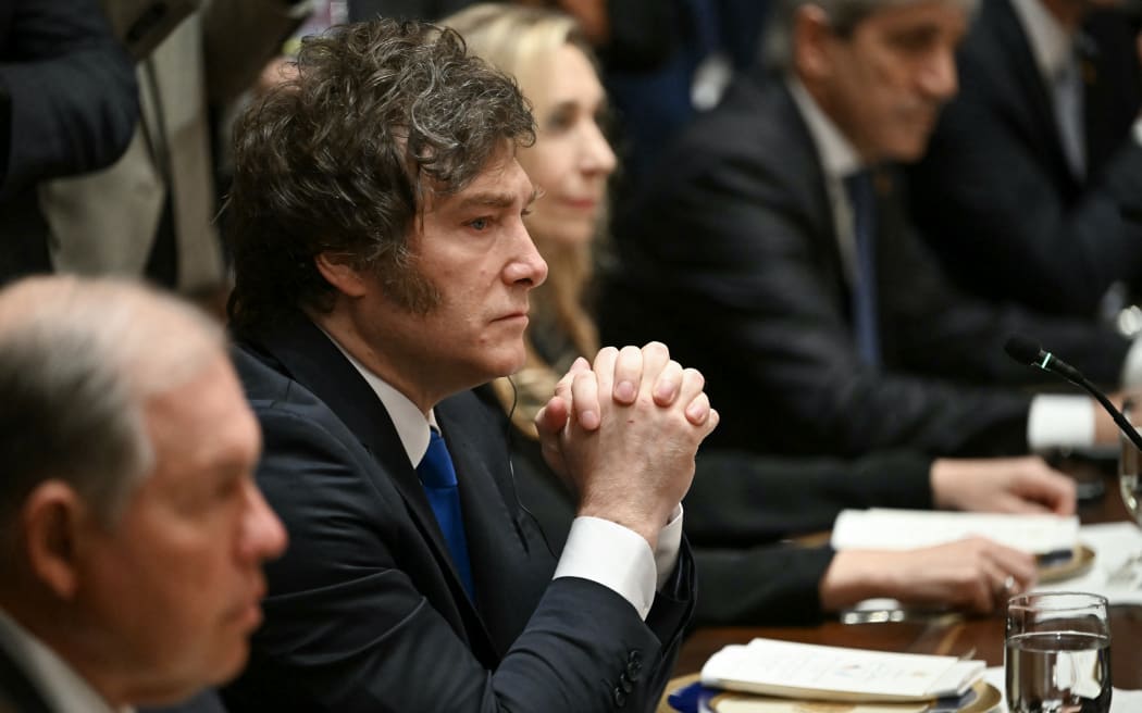 Argentina's President Javier Milei (2nd-L) looks on during a meeting with US President Donald Trump in the Cabinet Room at the White House in Washington, DC on October 14, 2025. (Photo by ANDREW CABALLERO-REYNOLDS / AFP)
